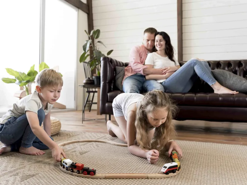 full-shot-parents-watching-children-play-min.jpg
