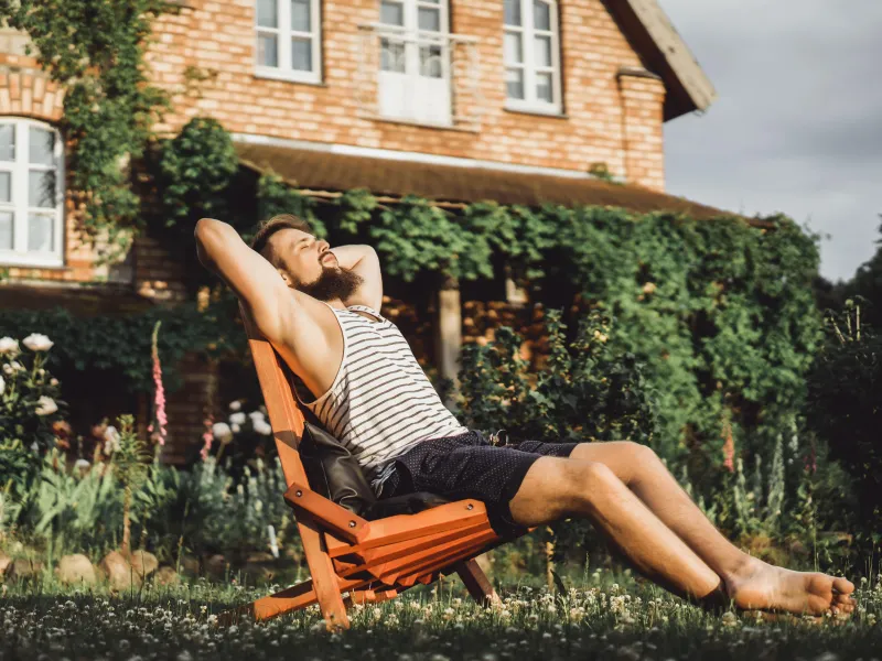man-is-resting-country-house-bearded-man-enjoys-sunset-green-lawn-min.jpg