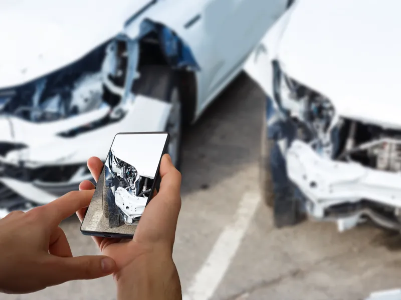 man-photographing-his-vehicle-with-damages-accident-insurance-with-smart-phone.jpg