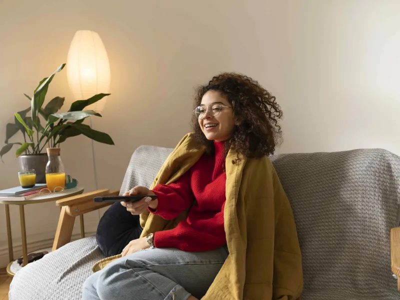 medium-shot-woman-holding-remote-min.jpg