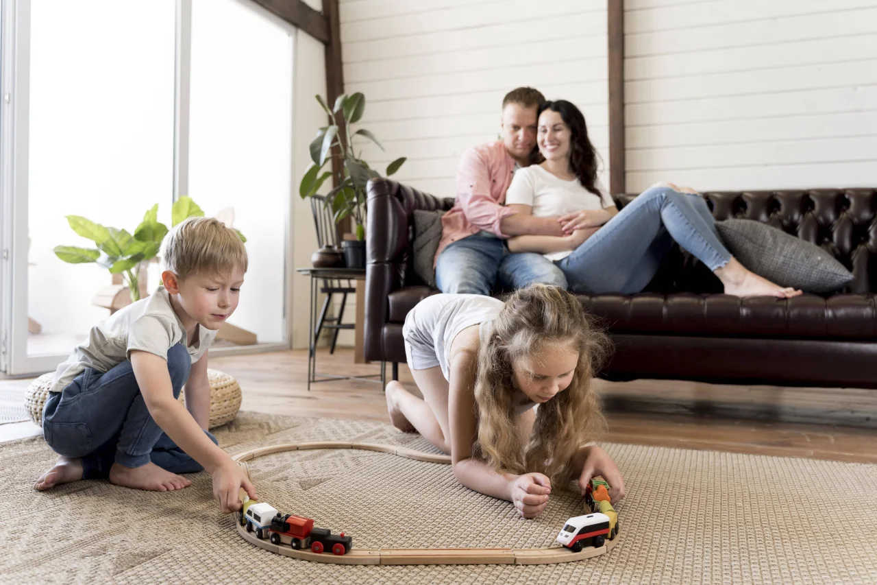 full-shot-parents-watching-children-play-(1)-min