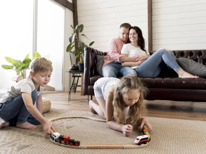 full-shot-parents-watching-children-play-(1)-min