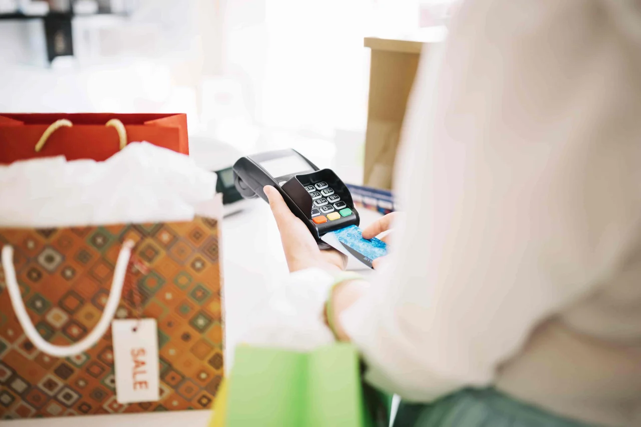 woman-putting-credit-card-into-payment-terminal-min-(1)