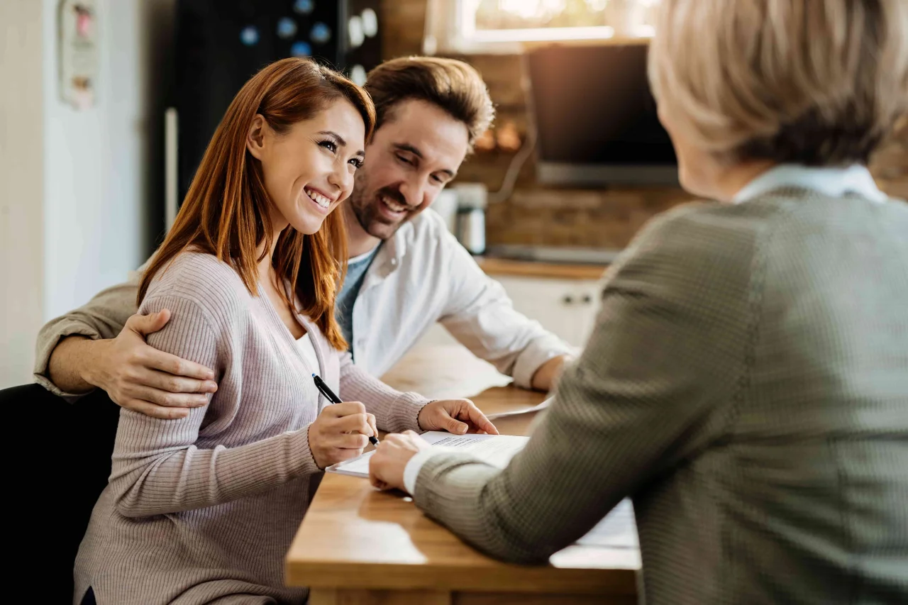 young-happy-woman-her-husband-signing-agreement-with-insurance-agent-meeting-min
