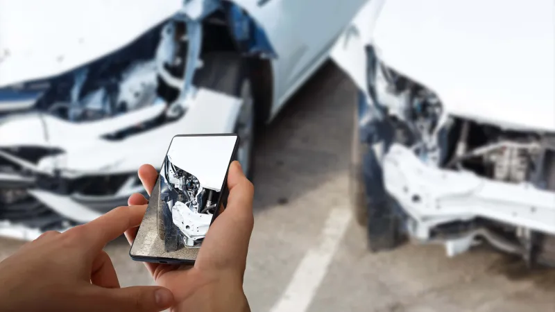 man-photographing-his-vehicle-with-damages-accident-insurance-with-smart-phone-(c)